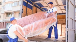 Movers carrying a large mattress