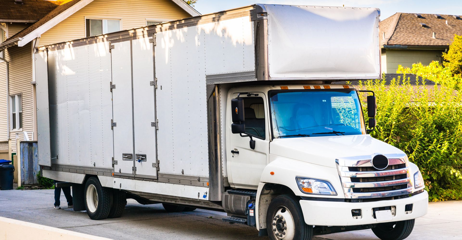 Moving truck parked in front of a house