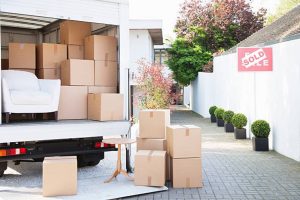 Furniture and boxes placed outside a truck indicating professional moving services