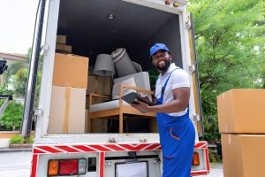 Delivery house move cargo truck service man checking box list from digital tablet for signature
