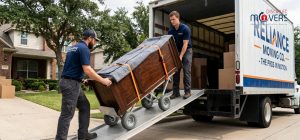 Professional movers using a ramp and high-quality dollies to load a large piece of furniture Professional movers using a ramp and high-quality dollies to load a large piece of furniture